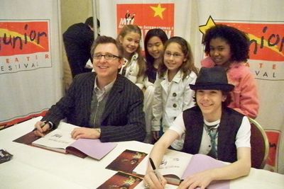 Thomas Schumacher and Henry Hodges sign copies of Ã¢â‚¬ËœHow Does The Show Go Photo